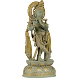 Brass Lord Krishna statue, angled side view, long plaited hair and raised arm gesture