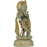 Brass Lord Krishna statue, angled side view, long plaited hair and raised arm gesture