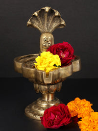 Brass Shivalinga idol on lotus pedestal with red and yellow flowers, 9-inch