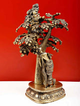 Natural brass Krishna and Radha sculpture, Krishna on mounted tree limbs, standing on round base