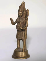 Small brass Lord Shiva statue side view, hands raised in blessing, on round base