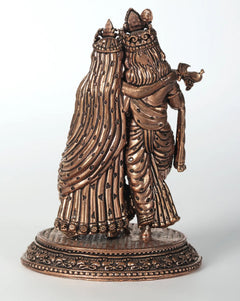 Rose-gold brass Radha-Krishna statue, rear/side view with flowing drapery