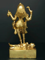 Back view of brass Kali statue standing on Shiva base, ornate draped skirt