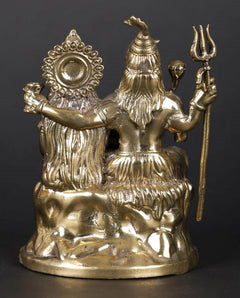 Brass sculpture rear/side view: Shiva with trident and raised hands, Parvati seated