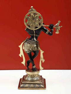 Back view of black brass Lord Krishna flute statue with decorative halo, 12 inch