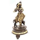 Venugopala brass idol, 10 in, standing on ornate dark base with gold accents