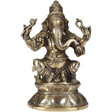 Brass Ganesha statue seated on double lotus pedestal, arms raised