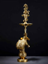 Brass Krishna flute lamp featuring elephant figure, ornate base and bowl top