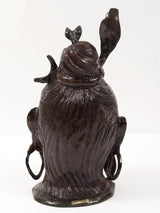 Lord Shiva head brass statue from behind, long textured hair and raised arms