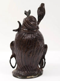 Lord Shiva head brass statue from behind, long textured hair and raised arms
