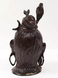 Lord Shiva head brass statue from behind, long textured hair and raised arms