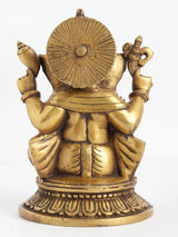 Back view of brass four-armed seated Ganesha statue with haloed back disk