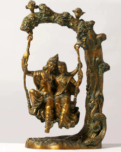 Brass Radha-Krishna swing statue, seated figures holding swing ropes, 18 cm