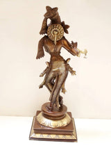 Rear view of natural brass Krishna statue, standing with raised flute hand