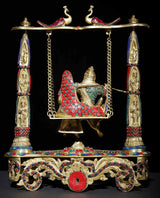 Brass Radha-Krishna swing statue with decorated cradle, red-blue inlay details, hanging chains