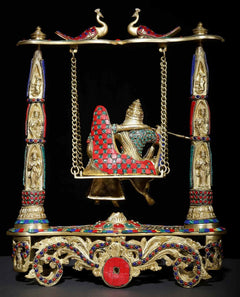 Brass Radha-Krishna swing statue with decorated cradle, red-blue inlay details, hanging chains
