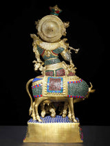 Brass Venugopal Krishna statue on cow, ornate back halo motif with inlay decoration