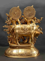 Brass Radha Madhav statue with cow, ornate back wheels and engraved detailing
