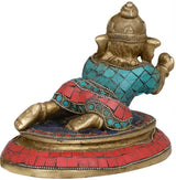 Brass Ganesha statue with turquoise red tiled patterns and ornate beaded border