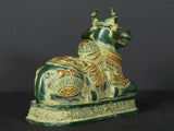 Side view Nandi brass statue on pedestal, detailed patterns on body and saddle