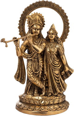 Natural brass Radha-Krishna idol with lotus-studded aureole and Krishna holding flute