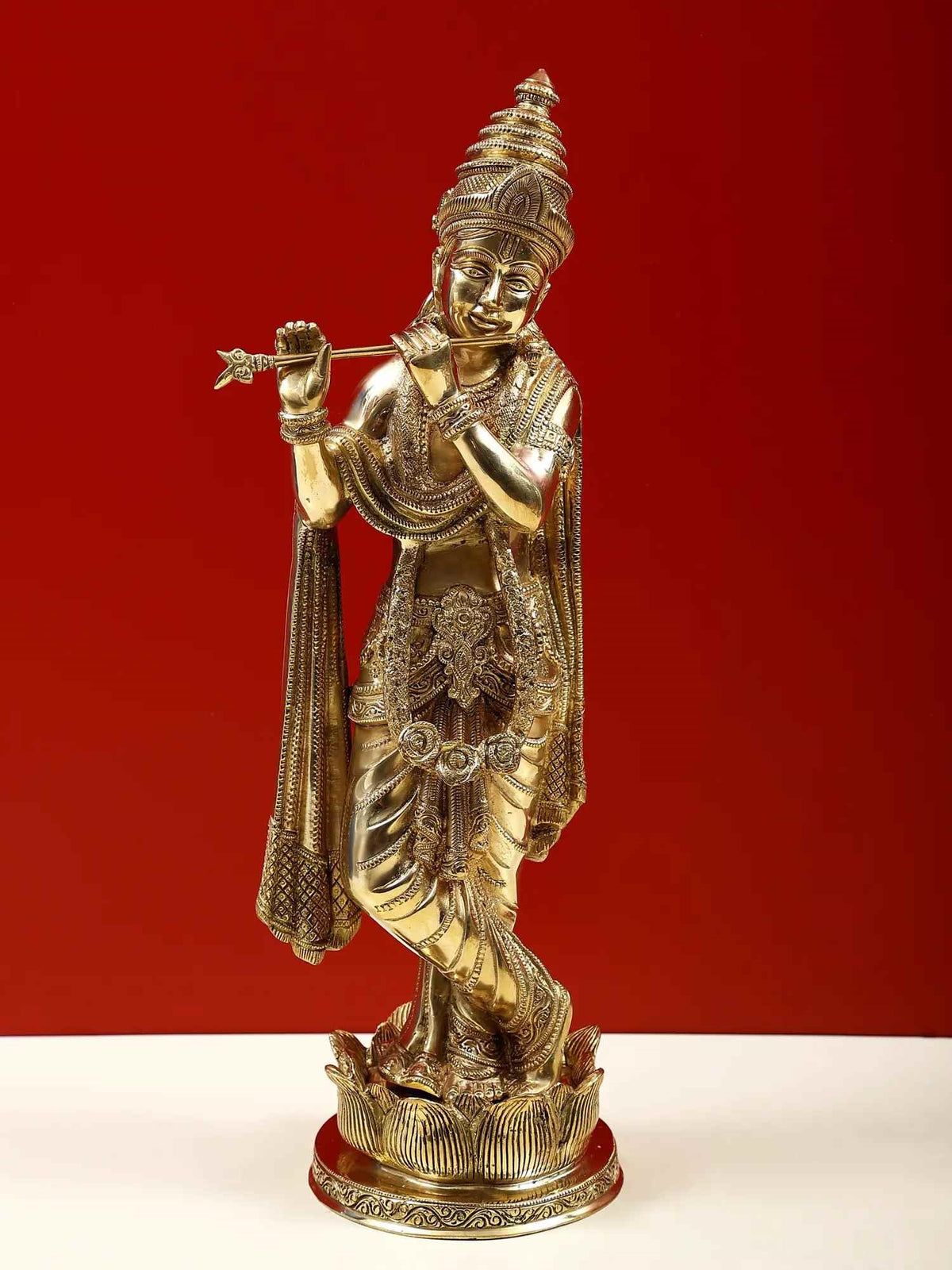Brass Krishna flute statue on lotus pedestal, raised hand and ornamented robe