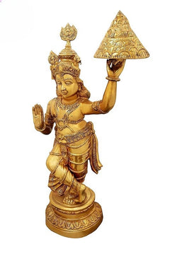 Brass Shri Krishna lifting Govardhana mountain sculpture, one hand raised in blessing