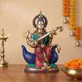 Saraswati brass idol seated on a swan, playing instrument with colorful inlay