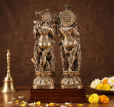 Brass Radha Krishna murti with circular halo details on elephant pedestals, wooden base