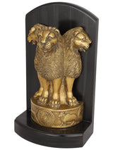Brass lion figurine with head details and wheel base, side angle on dark pedestal