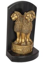 Brass Ashoka pillar lion figurine with wheel and animal reliefs on base, angled view