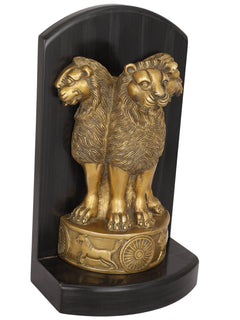 Brass Ashoka pillar lion figurine with wheel and animal reliefs on base, angled view
