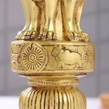 Brass lion capital pedestal with carved wheel and lion details above fluted column