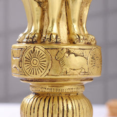Brass lion capital pedestal with carved wheel and lion details above fluted column