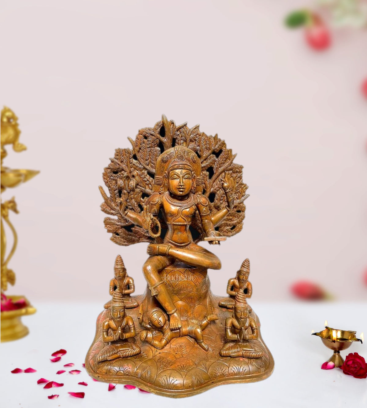 Bronze-finished brass Dakshinamurthy statue, seated with lotus and ornate aureole
