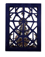 Brass Lakshmi idol from behind in lattice frame, with hanging bell chains