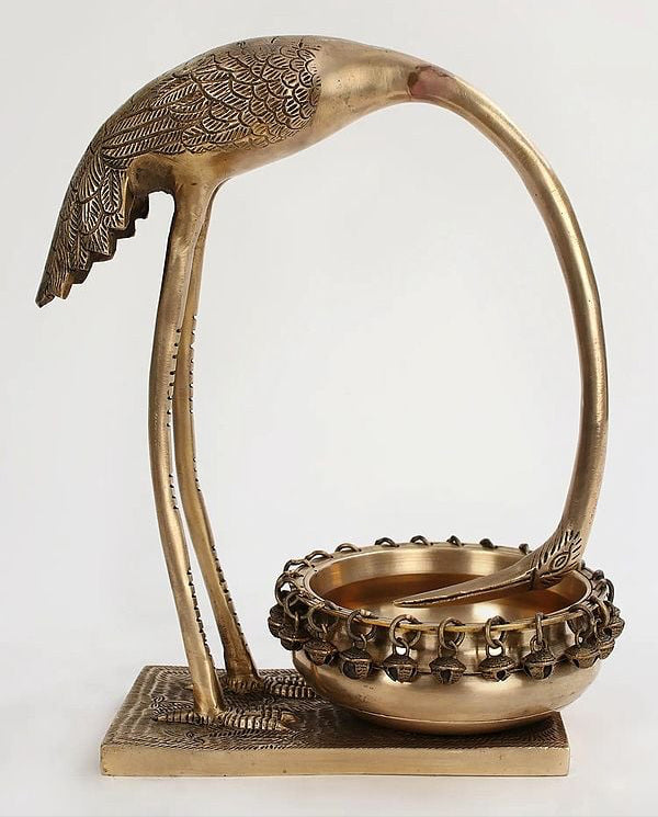 Brass leaning flamingo urli with leaf-textured body and raised tray base