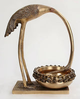 Brass leaning flamingo urli with leaf-textured body and raised tray base