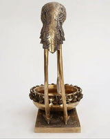 Brass flamingo urli from back: detailed wing texture and bowl rim with beads
