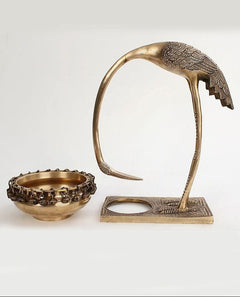 Brass leaning flamingo with urli set: curved neck, chain-rim bowl, square stand