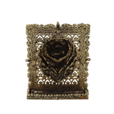 Brass lion face panel with openwork filigree frame and raised lion face detail