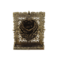 Brass lion face panel with openwork filigree frame and raised lion face detail