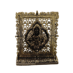 Antique brass dashboard panel back with ornate border and central deity relief