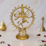 Gold-toned Nataraja brass sculpture: dancer with multiple arms inside ornate circular halo