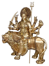 Brass Durga statue seated on lion, raised tridents and weapons, front view