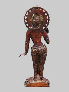 Standing Tara brass idol back view, circular halo detail, engraved dress pattern