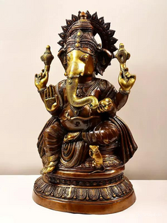 Brass Ganesha statue in profile view, ornate crown, trunk, and jewelry details