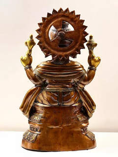 Rear view of brass Ganesha sculpture, circular spoked halo and patterned back drapery