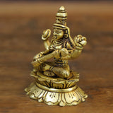 Maa Saraswati brass figure seated on lotus base, arms extended