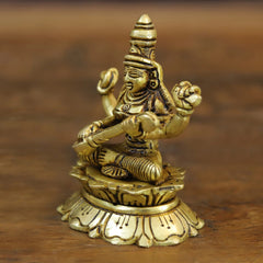 Maa Saraswati brass figure seated on lotus base, arms extended